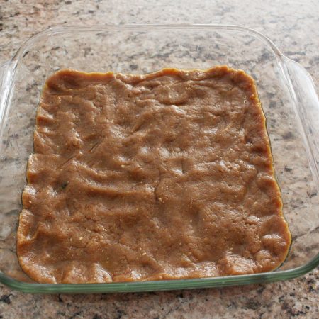 Press peanut mixture into the bottom of a glass baking dish